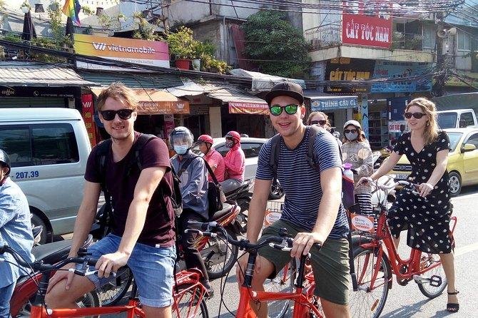 Tour group cycling through temple complex in Hanoi