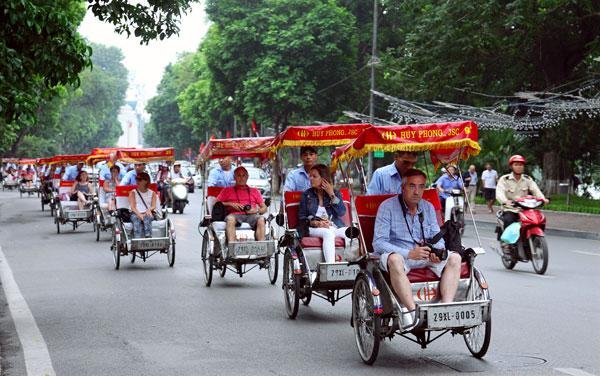 Traditional cyclo passing through Hanoi French Quarter streets