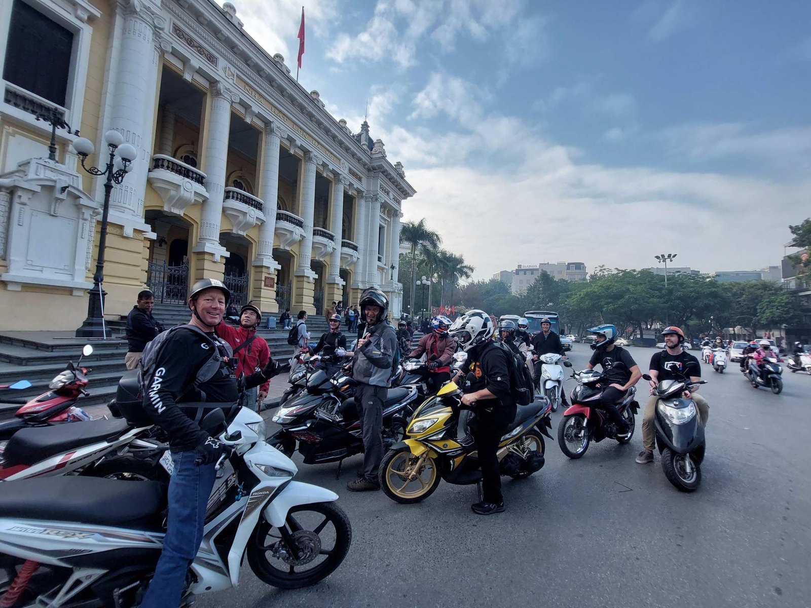 Motorbike rider navigating through typical Hanoi traffic
