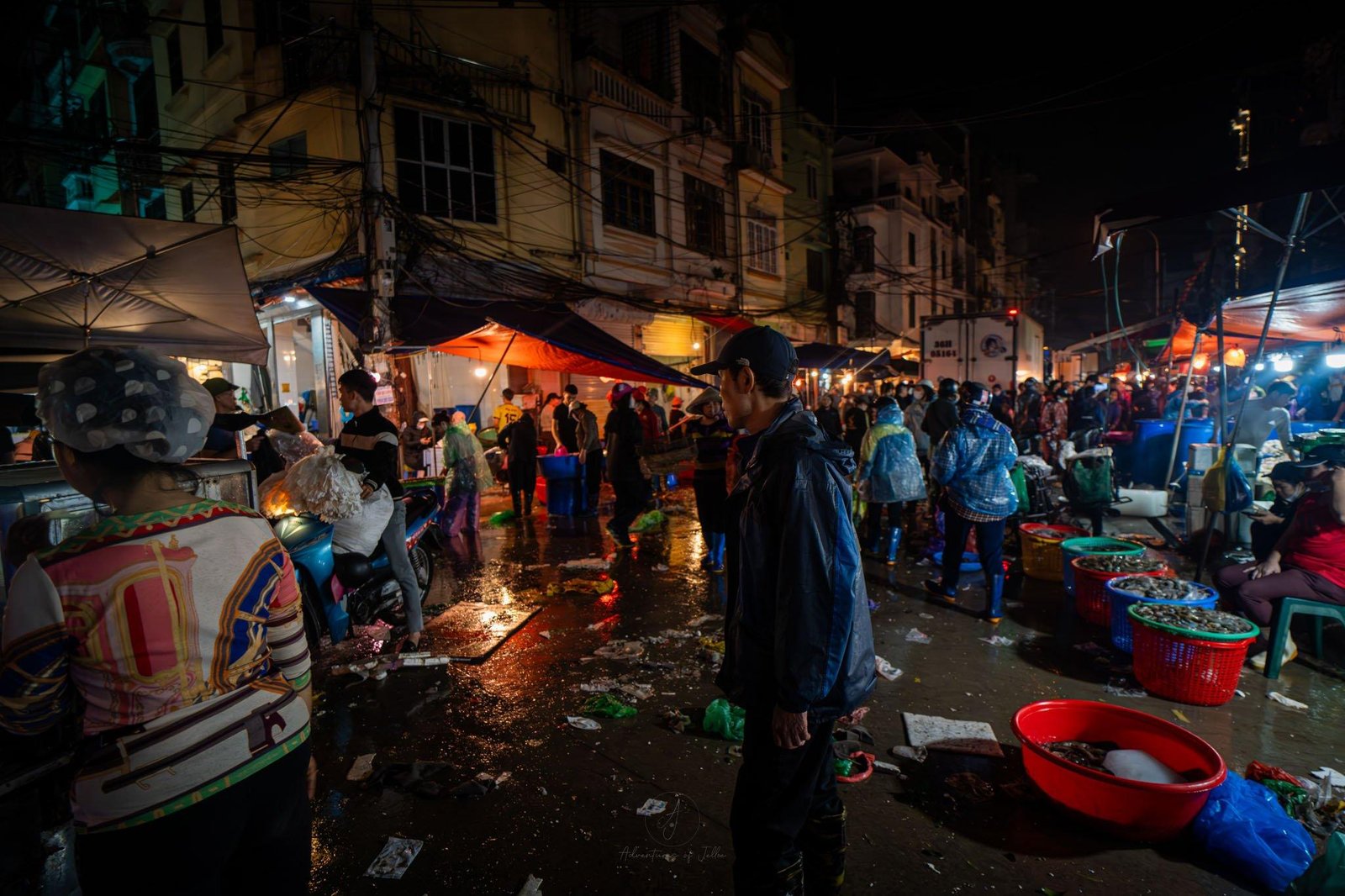 Tourists enjoying Hanoi street food at night
