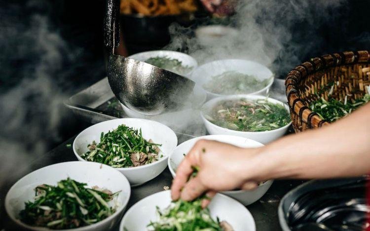 Local cook demonstrating traditional Vietnamese cooking techniques