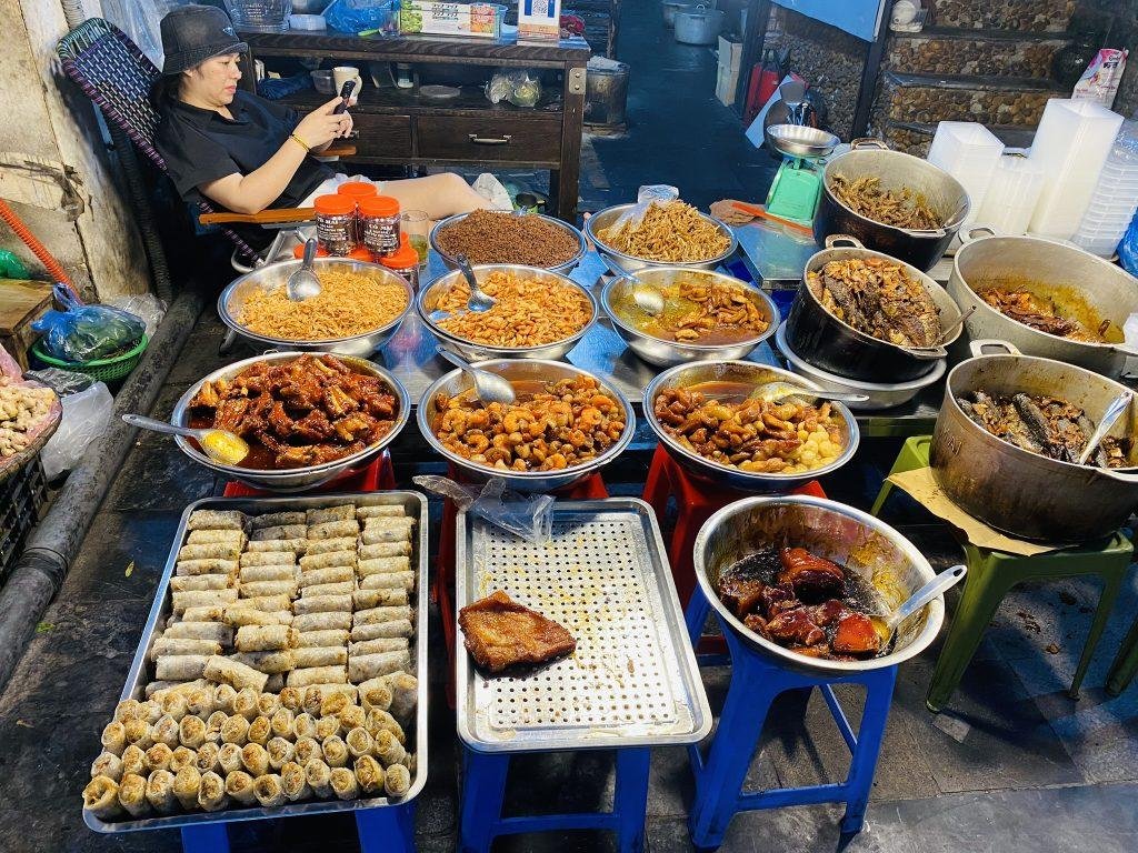 Street vendor cooking traditional Vietnamese food in Hanoi Old Quarter