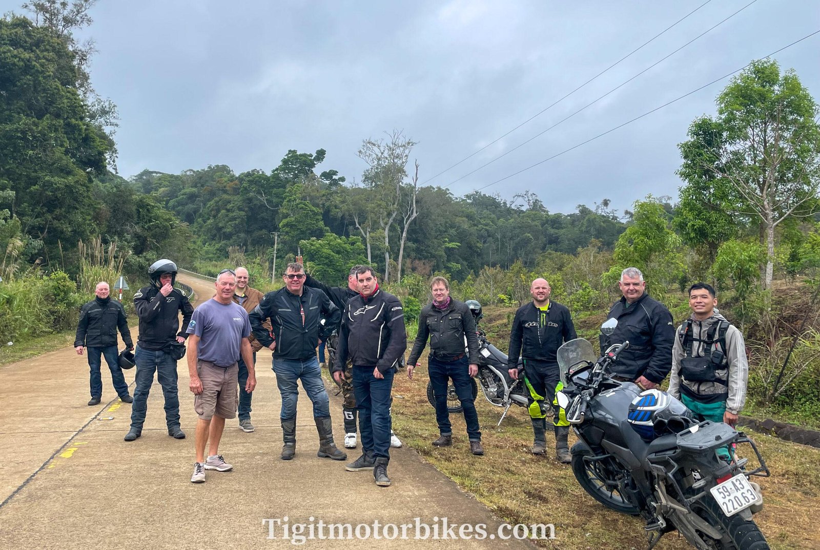 Group of motorcycle riders stopping for a view during guided tour