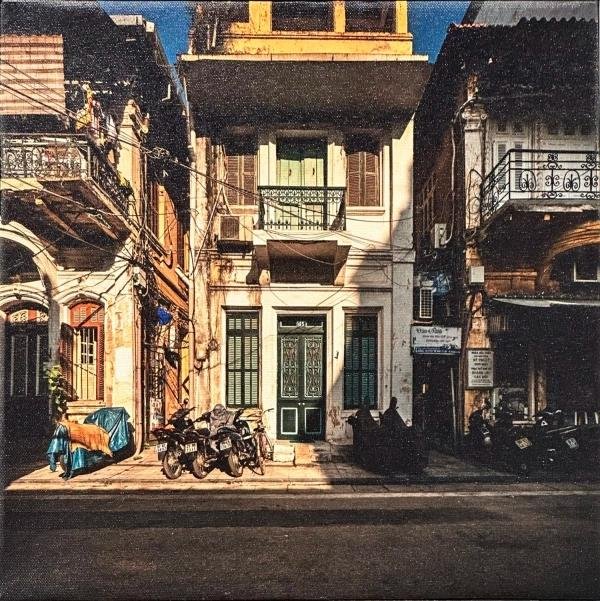 Photographer capturing colonial architecture in Hanoi French Quarter
