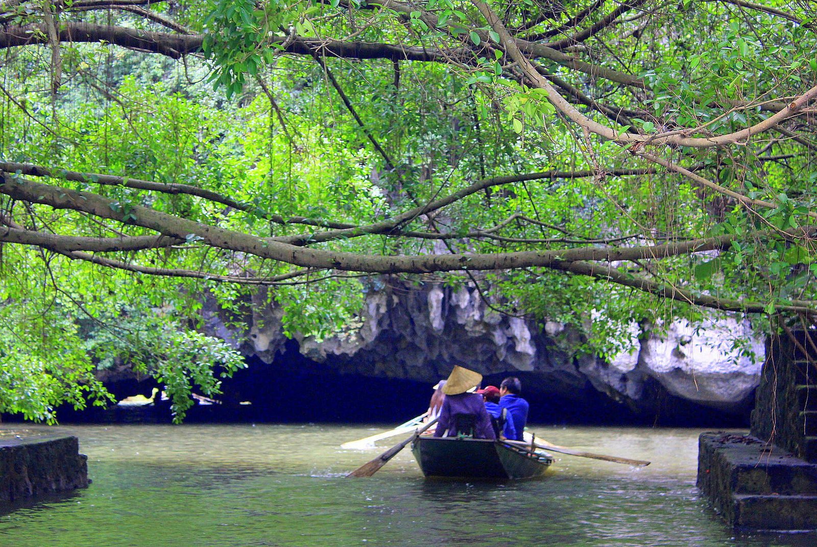 Traditional boat ride through the limestone karsts of Tam Coc, Ninh Binh