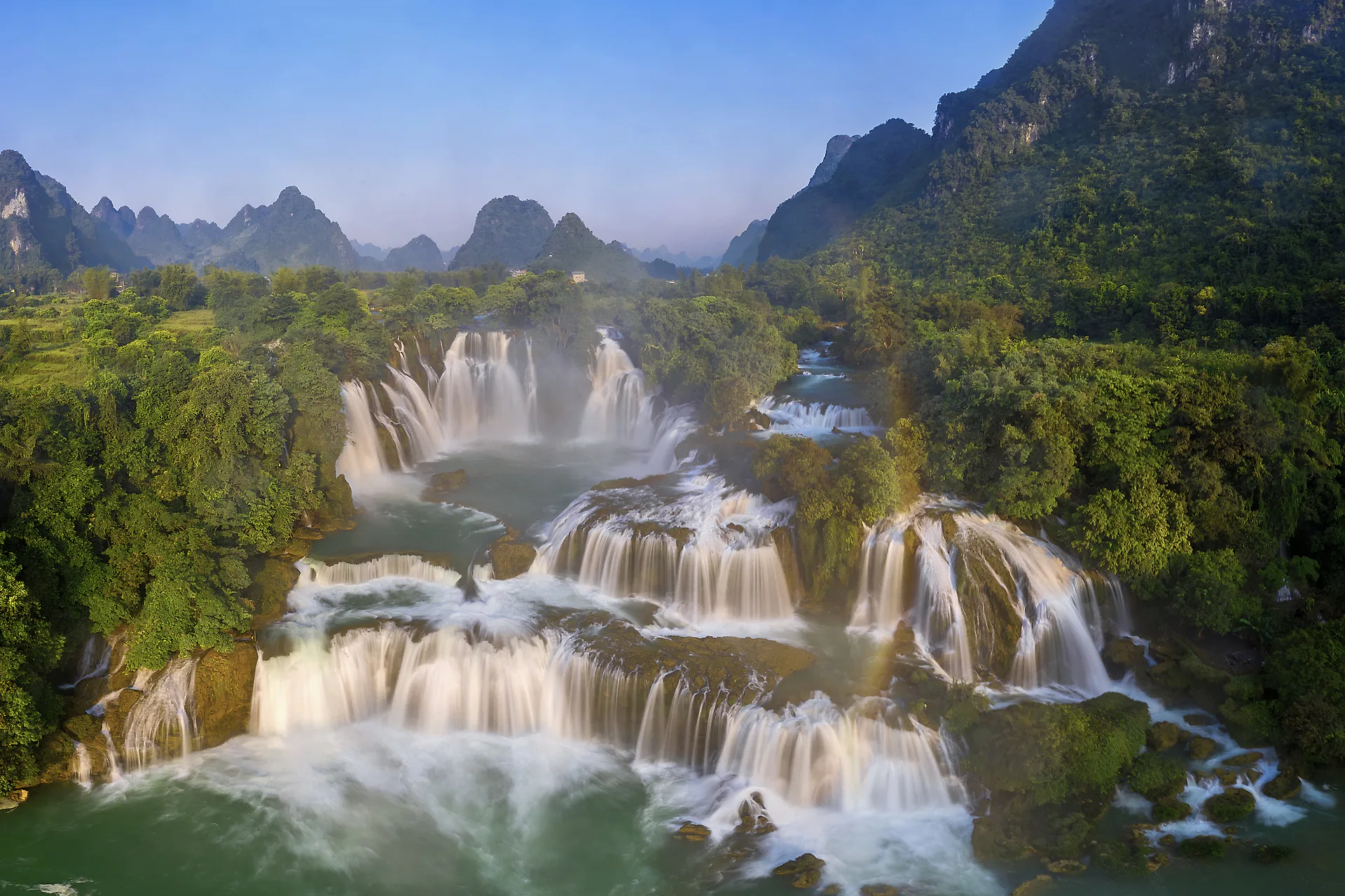 Ban Gioc Waterfalls surrounded by limestone mountains in Vietnam