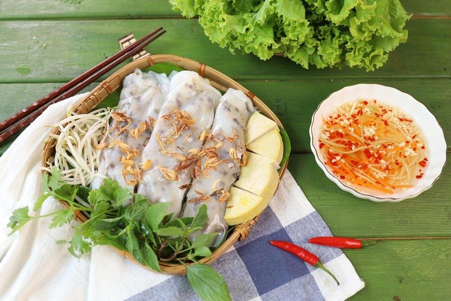 Expert preparing delicate banh cuon rice paper rolls