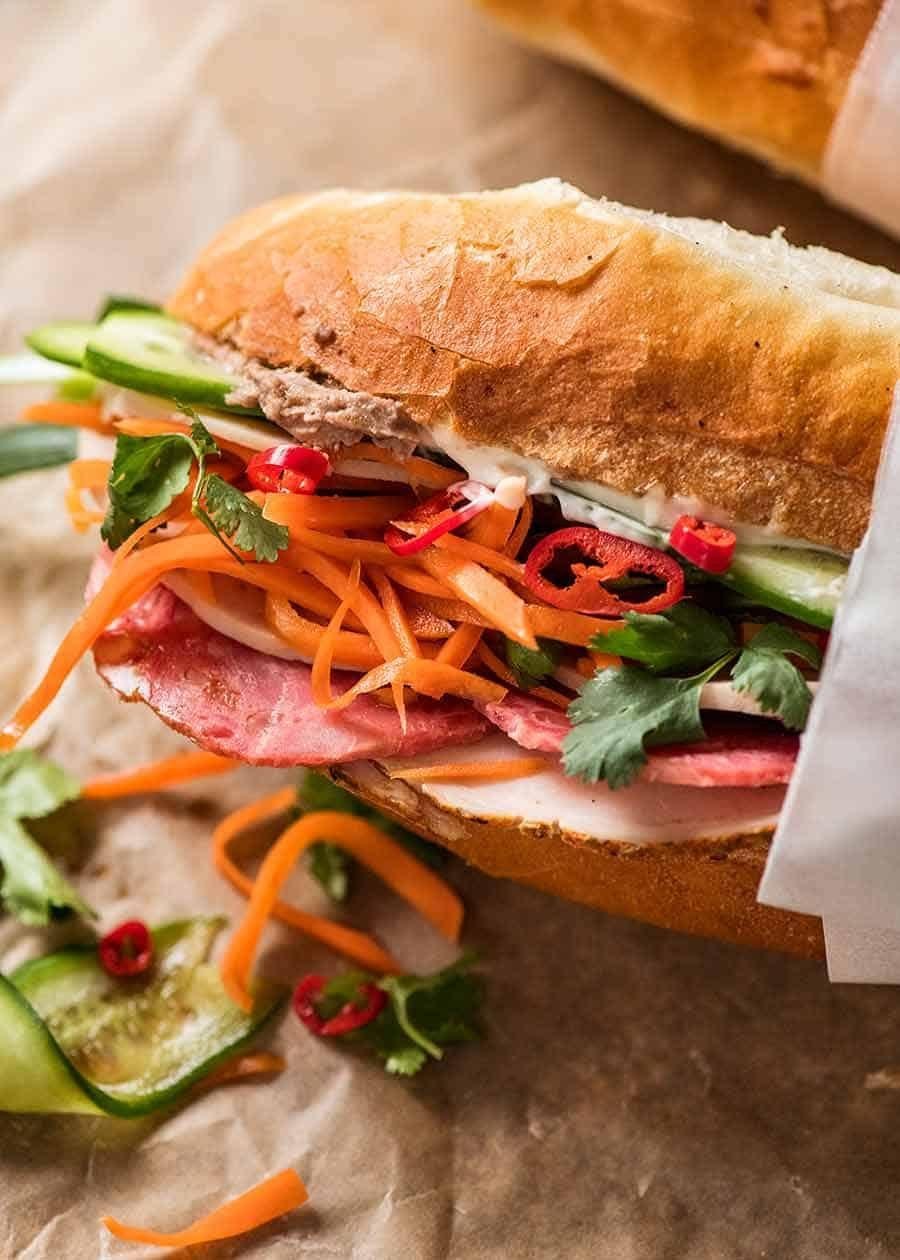 Close-up of a freshly made banh mi sandwich showing layers of ingredients