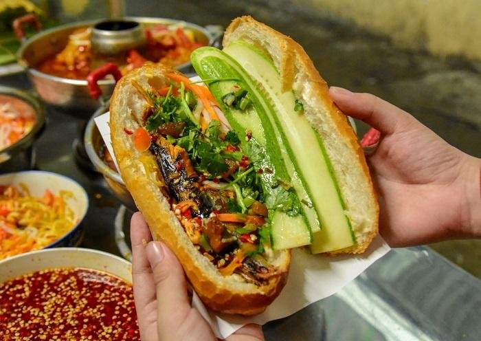 Street vendor preparing traditional banh mi sandwiches
