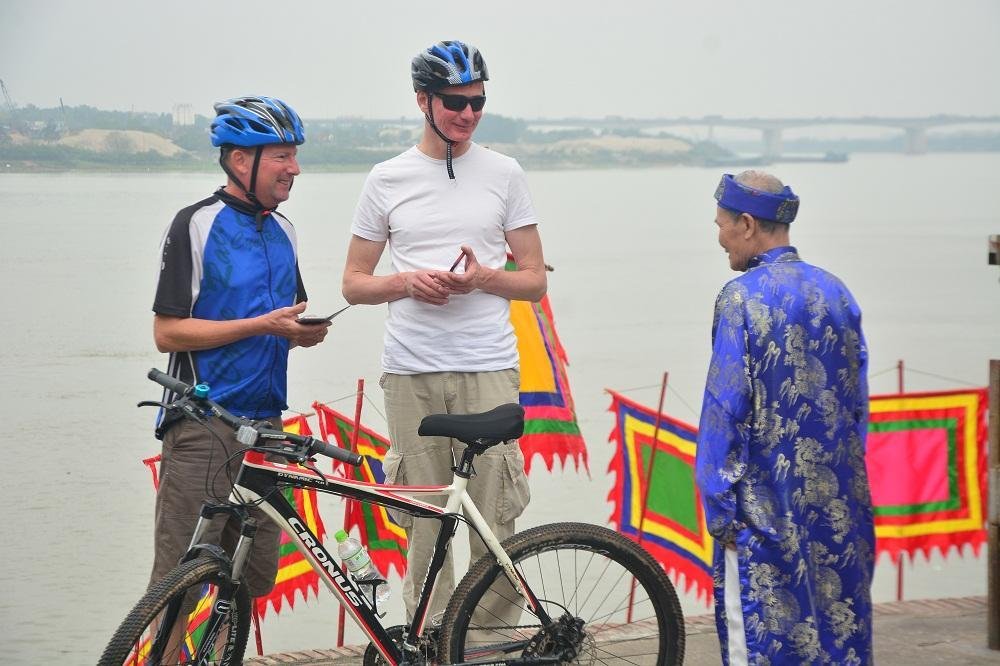 Cyclists exploring the historic Bat Trang pottery village outside Hanoi