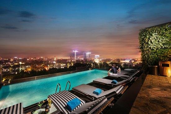 Hotel concierge helping guests plan Hanoi tours and experiences
