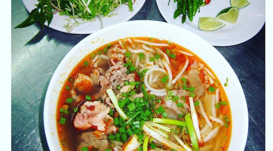 Bowl of vegetarian bun bo hue with fresh herbs and vegetables