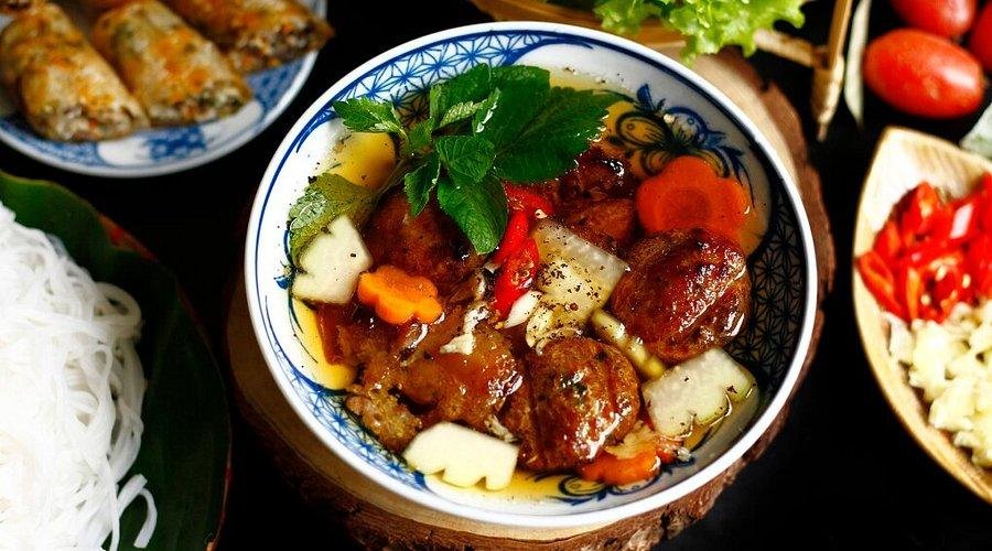 Traditional bun cha being grilled over charcoal in Hanoi