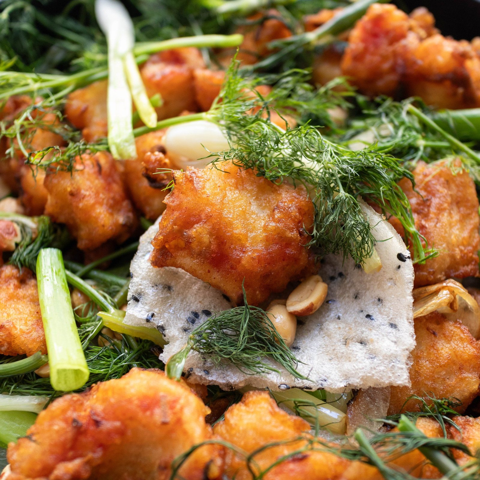 Traditional cha ca la vong dish with turmeric fish and dill being cooked at table