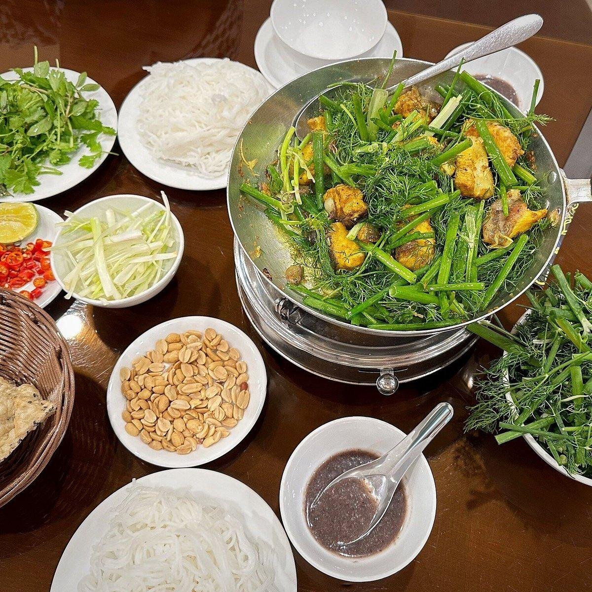 Traditional cha ca la vong being prepared tableside