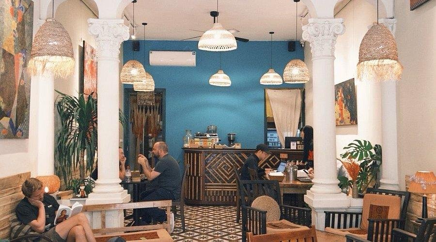 Modern cafe in Hanoi Old Quarter with stylish interior and customers enjoying coffee