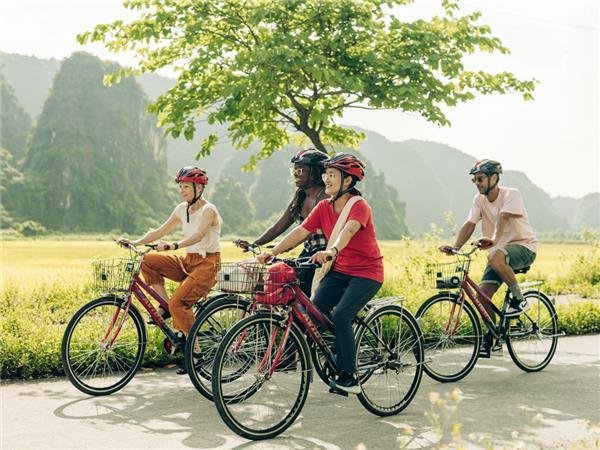Happy cyclists enjoying countryside views in Vietnam