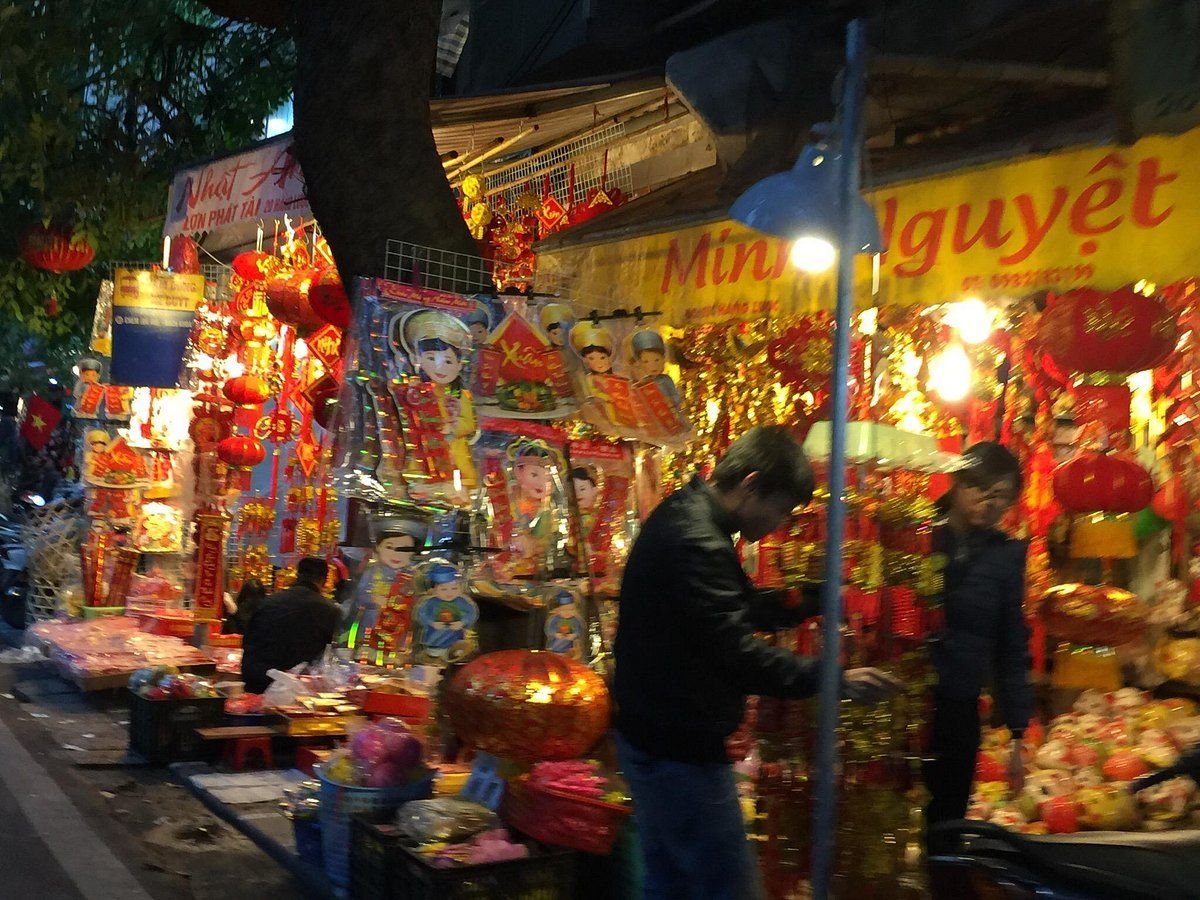Bustling night market scene with street food vendors in Hanoi