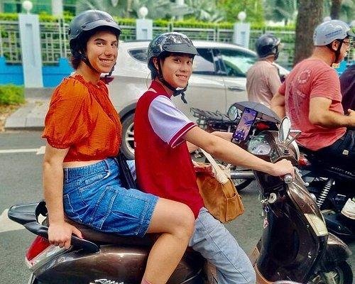 Experienced local guide giving tips to tourists on vespa food tour