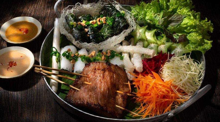 Traditional family-style Vietnamese dinner with multiple shared dishes