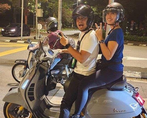 Family preparing for vespa tour with safety briefing