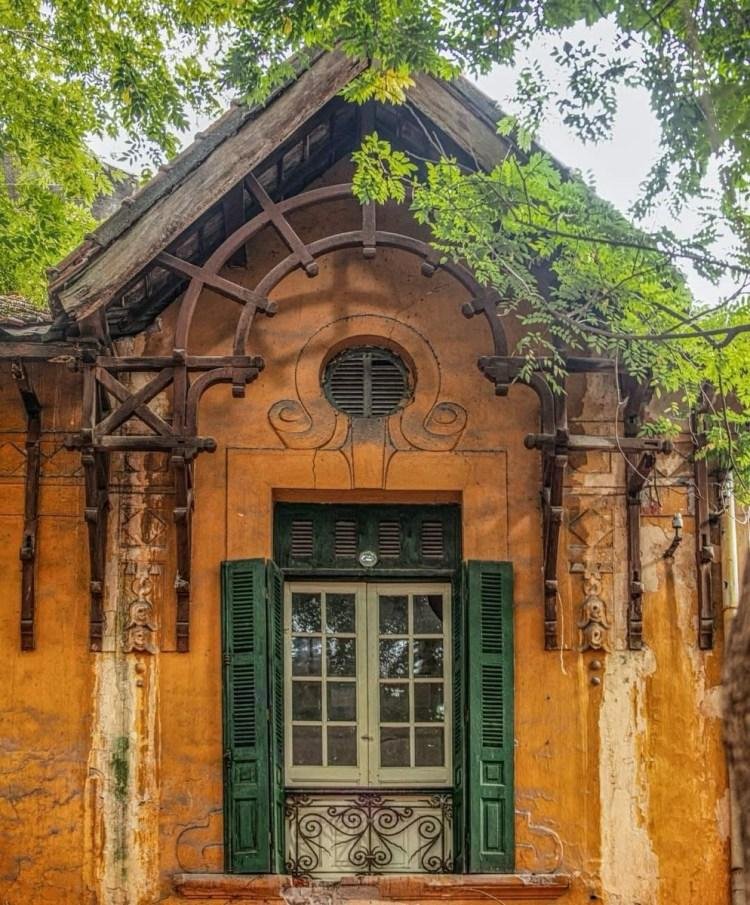 French colonial buildings with yellow walls and green shutters in Hanoi
