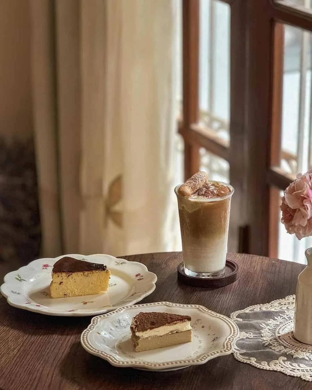 Traditional Vietnamese coffee served with French pastry on vintage table