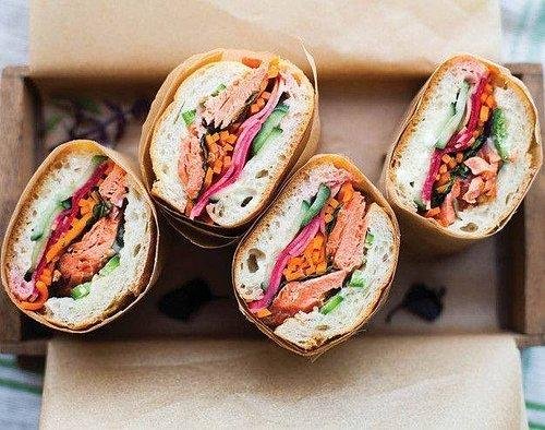 Street vendor preparing fresh banh mi sandwich