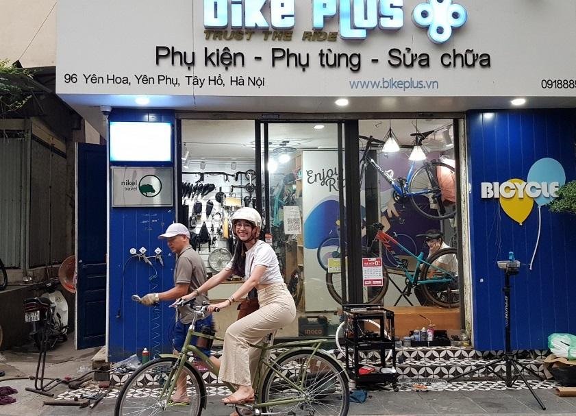 Tourist renting a bicycle from a local shop in Hanoi