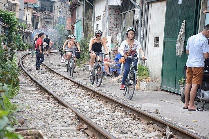 Tourists cycling through Hanoi Old Quarter streets