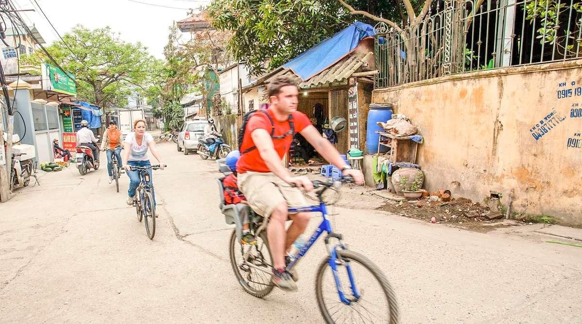 Tourists cycling through rural villages near Hanoi