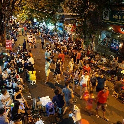 Entrance to a popular nightclub in Hanoi Old Quarter with people waiting in line