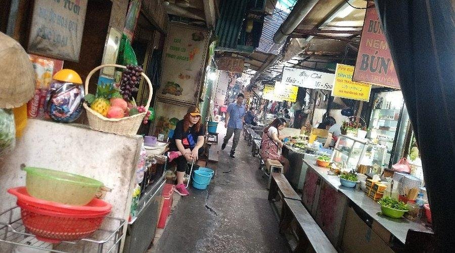 Small group exploring fresh ingredients at Dong Xuan Market in Hanoi