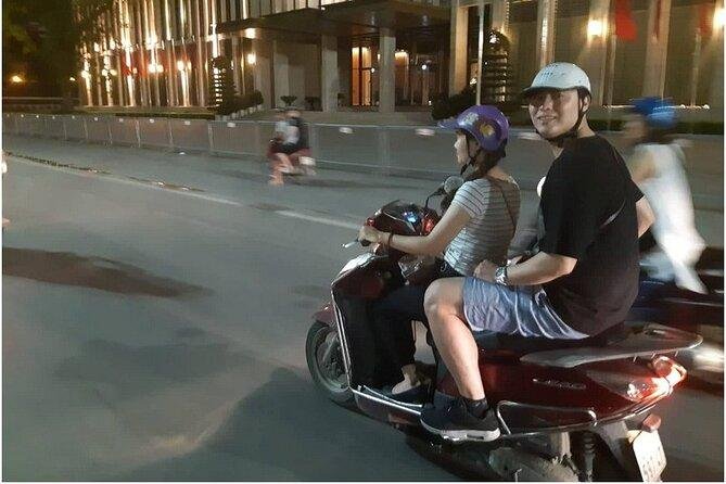 Bustling Hanoi evening food market with motorbikes