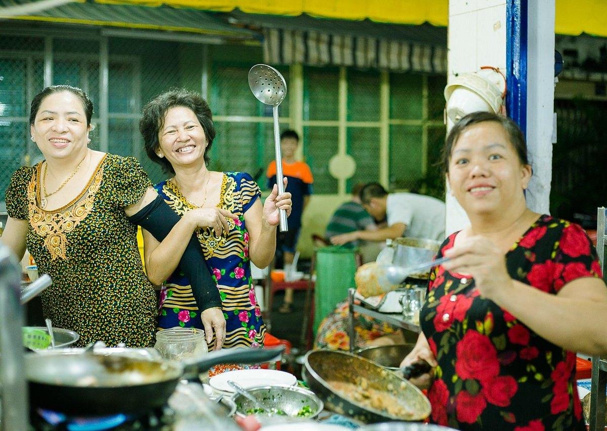 Food blogger filming Vietnamese street food preparation
