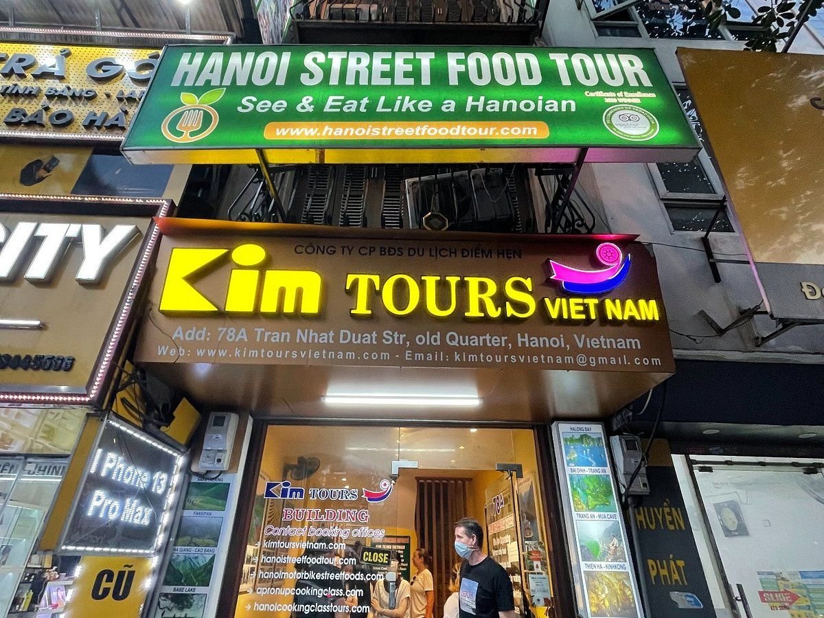Tourist booking private food tour on smartphone in Hanoi