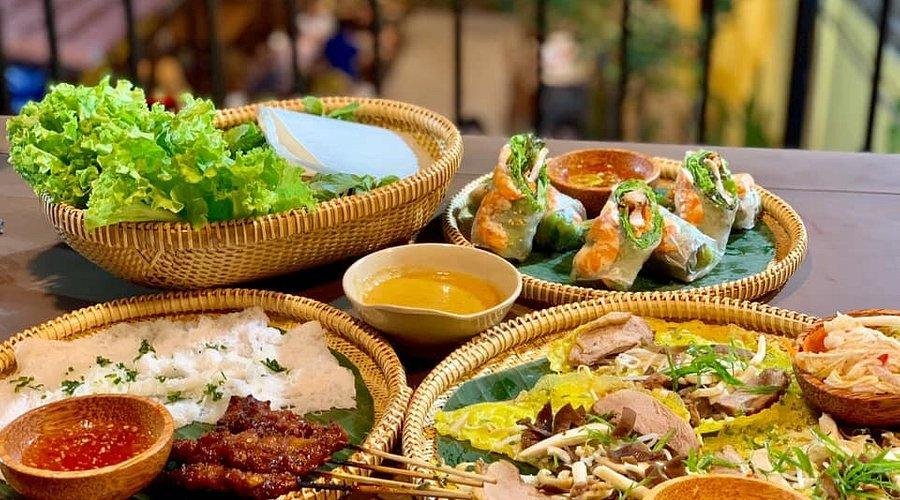 Local food vendor preparing traditional Vietnamese dishes