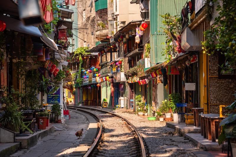 Peaceful tree-lined street in Hanoi French Quarter with cafes and colonial architecture