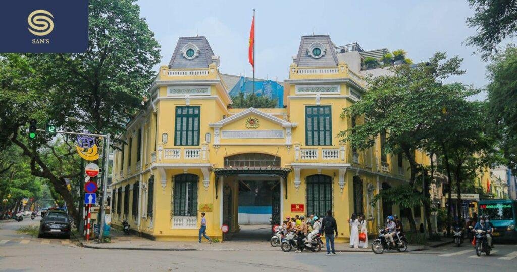 Tour group walking through Hanoi French Quarter with colonial architecture