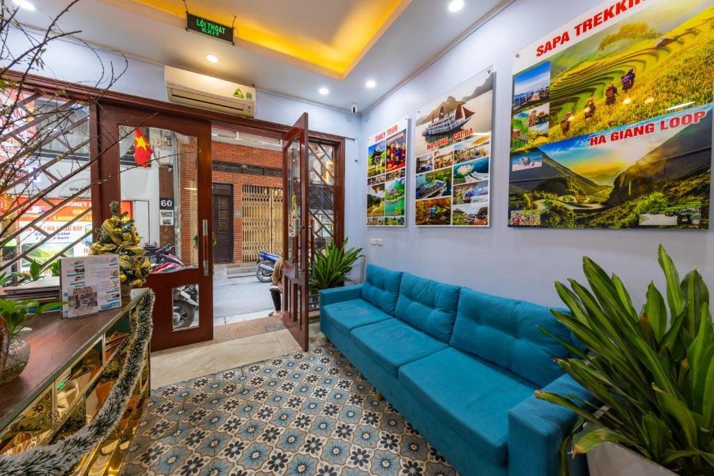 Travelers sharing information in a Hanoi hostel common room