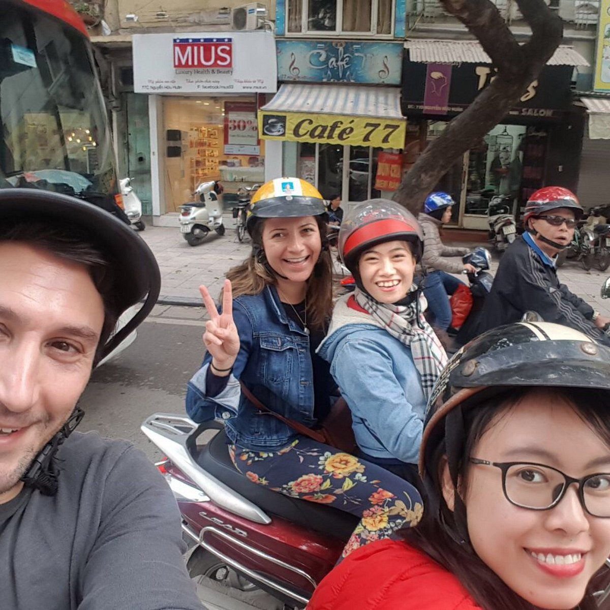 Tourists enjoying street food on motorbike tour in Hanoi