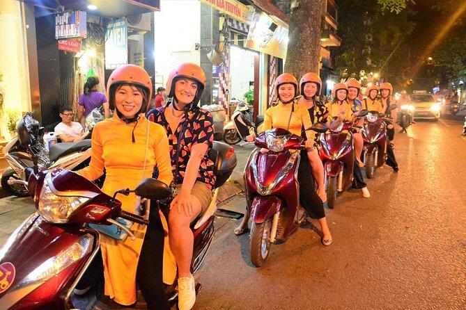 Tourists enjoying food on a Hanoi motorbike food tour