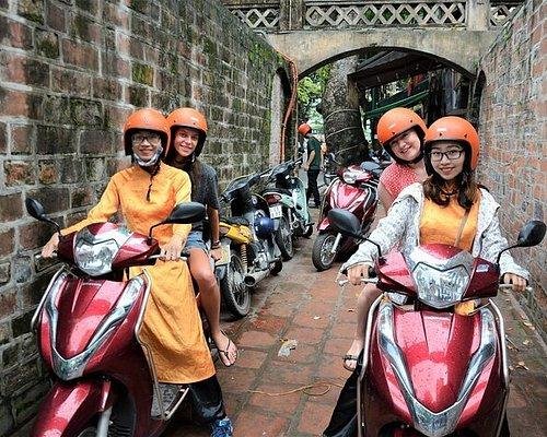 Tourist wearing safety helmet on Hanoi motorbike tour