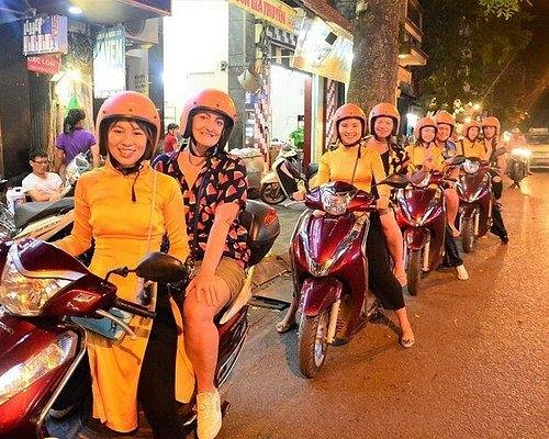 Busy motorbike traffic in Hanoi streets with drivers navigating through tight spaces