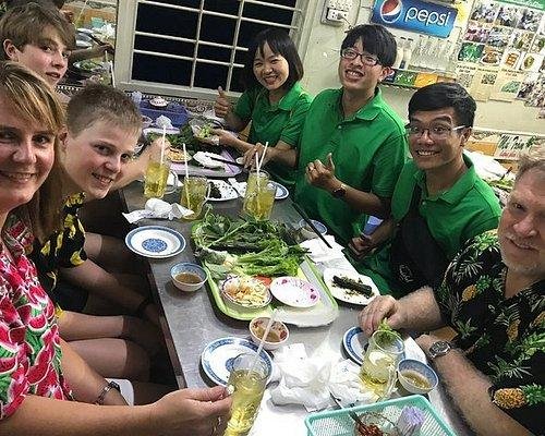 Tourists preparing for night food tour with proper attire