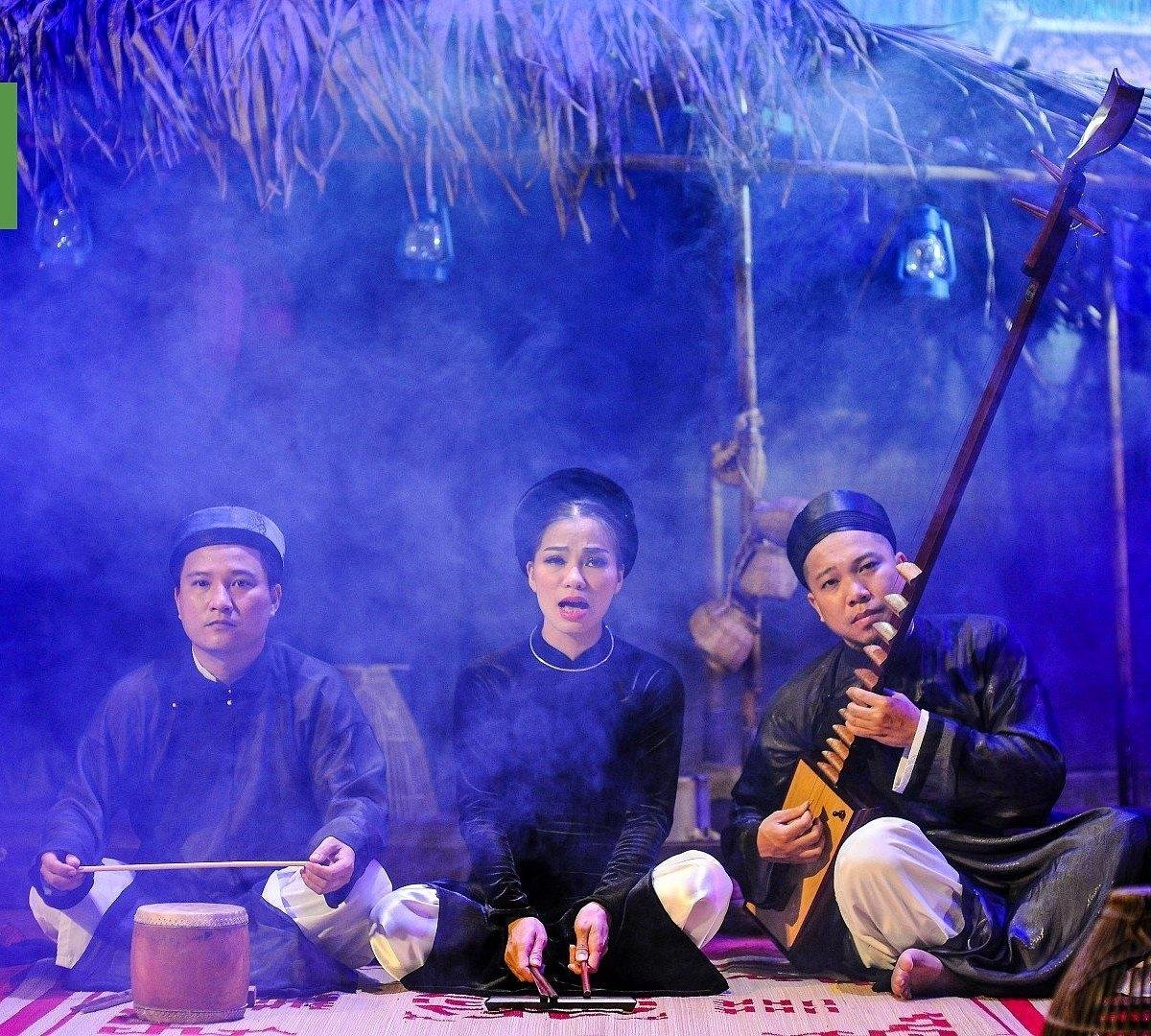 Traditional Vietnamese musicians performing for a crowd at the Hanoi Night Market