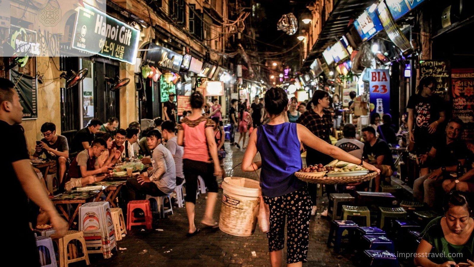 Tourists shopping for colorful souvenirs at the Hanoi Old Quarter Night Market