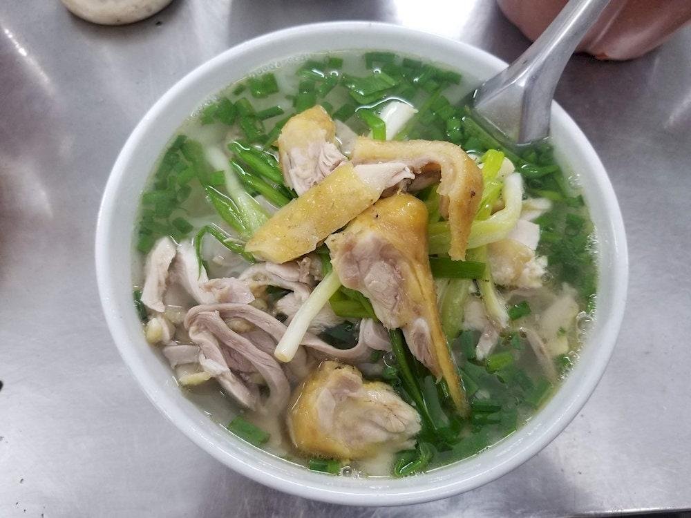 Steaming bowl of chicken pho served at night street stall