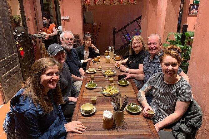 Small group enjoying night street food tour in Hanoi Old Quarter