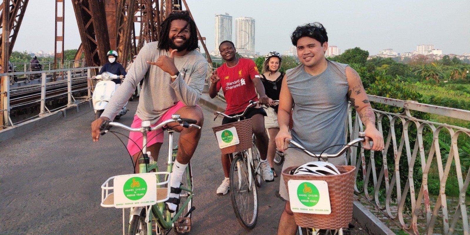 Group of tourists cycling through the historic Old Quarter of Hanoi